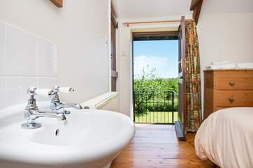 The door from the double bedroom leads out to set a stairs which take you down to the garden.