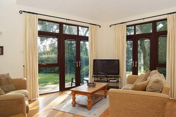 High ceilings and tall glazing makes the sitting/dining-room very light.