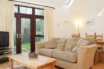 Two sets of French doors open onto the patio and garden.