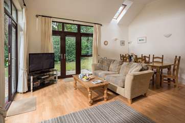 High ceilings and tall glazing makes the sitting/dining-room very light.
