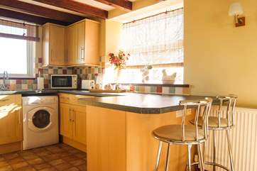 The kitchen has a useful breakfast-bar.
