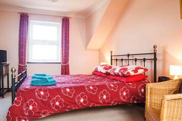Bedroom 1 shares the wonderful sea views.