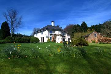 The house has a huge garden with totally unspoilt views over the Exmoor hills. The little stone building to the right is a storage barn not another cottage.