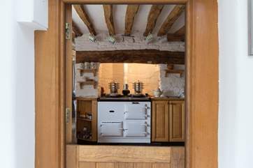 A boot-room with a stable-door leads through to the kitchen with its warming Aga.