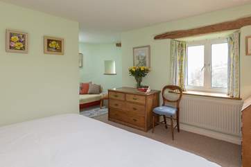 To one corner is a little sofa - a peaceful tucked away area making the most of the historic roundel which is part of the original design of this house