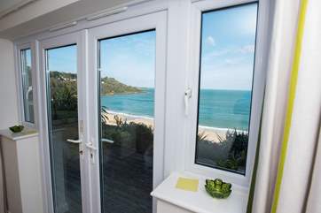 Doors lead out to the balcony from the master bedroom.