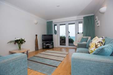 The sitting/dining-room has sea views.