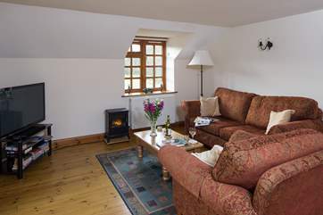 Cuddle up on the sofa to watch a late film on the television.
