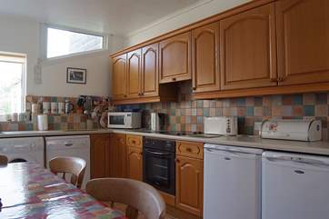 The well-equipped kitchen/breakfast-room has a large farmhouse dining-table.