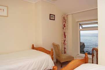 There are sea views from this twin bedroom.