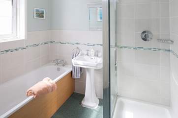 The first floor family bathroom has a shower cubicle.