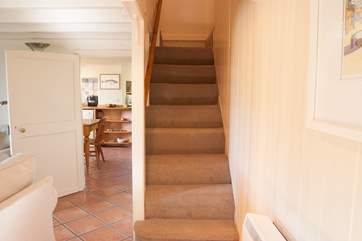 The stairs rise up from the sitting-room to the bedrooms with a split level landing at the top.