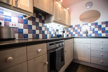 The galley kitchen is small but fully equipped.