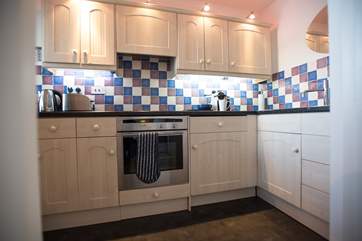 Spotlights highlight the worksurfaces in the kitchen.