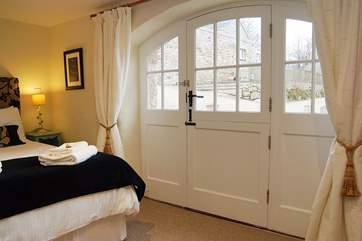 This spacious bedroom is beautifully furnished and has its own en suite shower-room.