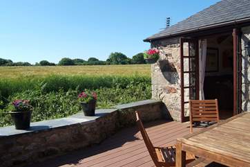 The deck looks out across fields and woodland in the distance.