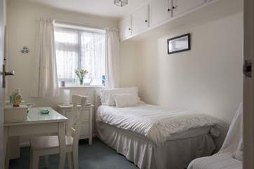 The single bedroom also has views over the back garden.