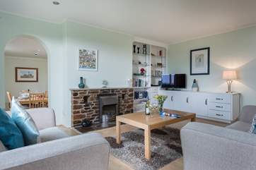 The spacious sitting-room leads through to the dining-room, both with lovely views over the garden.