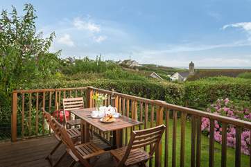 The sitting-room has patio doors opening onto the raised deck (which has steps down to the garden), from where the sea views are best.