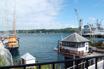 There are fabulous views across the moorings and harbour from the first floor sitting-room, with the lifeboat on the left and an RFA supply ship on the right on the day this picture was taken.