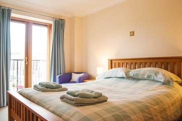 Bedroom 3 has a king size bed and doors out to a balcony.
