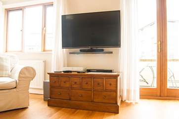 There is a big wall-mounted TV, perfect for family film nights.