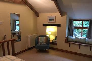 A place to sit in the generously-sized bedroom.