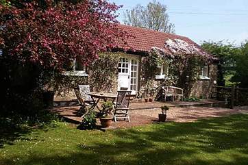 Little Yeo is a very pretty single-storey cottage, covered in clematis in the spring, and with a large garden.
