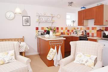 The kitchen-area is cleverly tucked away in one corner, allowing plenty of space in the rest of the room.