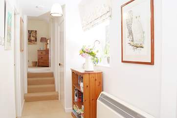 The master bedroom is up a short flight of stairs at the far end of the cottage.