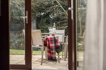Double doors from the conservatory open onto the patio.