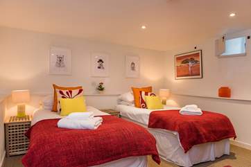 Bedroom 2 has lovely bright cushions and throws.