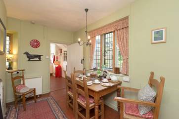 The dining-room also has a wood-burner, you can see the kitchen beyond it.
