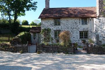 Week Cottage is the left-hand part of this lovely stone cottage, through the left-hand gate. To the left again is the little cottage garden.