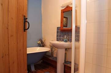 The pretty bathroom is off the first floor lading. It has a roll-top bath as well as a separate shower.