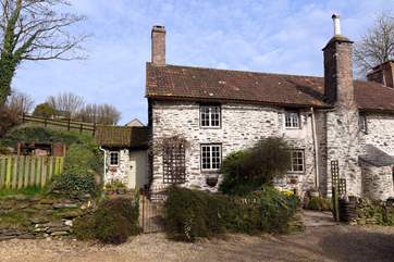Week Cottage is the left-hand part of this historic farmhouse. Its dedicated garden is to the left of the porch in this photograph.