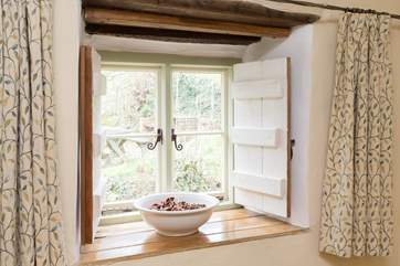Handmade shutters add to the cosy feel of this welcoming little cottage.
