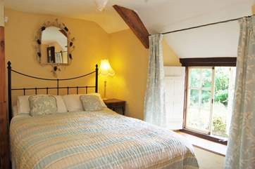 The pretty double bedroom looks out to the front of the cottage.