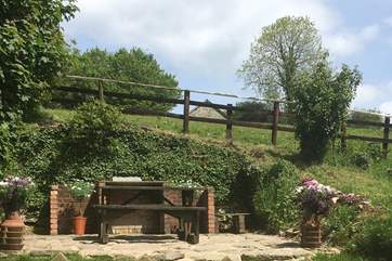 The garden has a lawned area, a paved terrace, seating and a barbecue. There are just a few stone steps up to the garden.