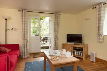 Looking out from the living area to the patio and your own walled garden - the private parking area is just beyond.