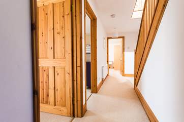 The ground floor hallway with three bedrooms on this floor.