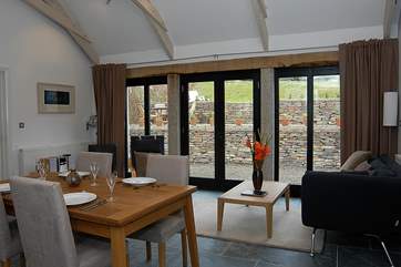 The open plan living room is wondefully light and the large windows open directly onto the sun drenched patio.