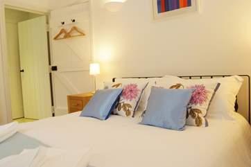 Crisp white bed linen and attractive furnishings in both bedrooms.