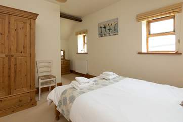 The en suite is at the far end of the room.