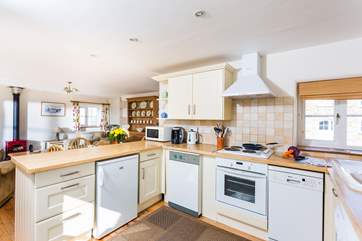 The well-equipped kitchen is open plan.