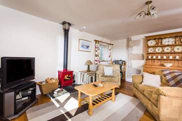The comfy sofas and armchairs surround the wood-burner.
