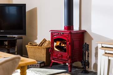 A lovely red wood-burner to keep you cosy on those cooler days and evenings.