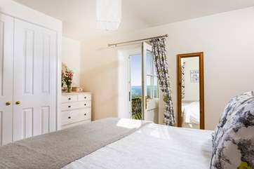 The double bedroom has a door opening onto the raised decked balcony.
