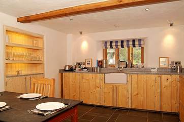 The kitchen units, with granite worktops, are beautifully constructed from reclaimed timber.