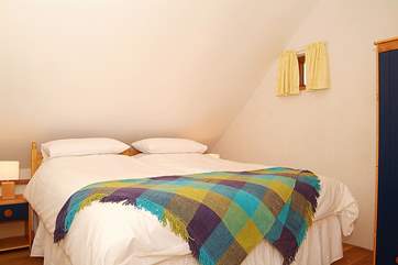 The bedroom upstairs is tucked beneath the eaves and has a separate WC and wash-basin. This picture shows the room set up as a double. (Bedroom 2).